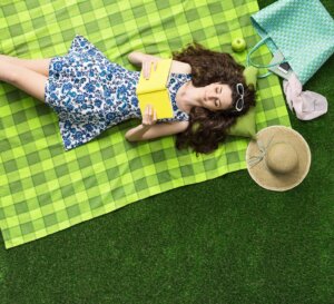 girl relaxing outdoors on the artificial turf